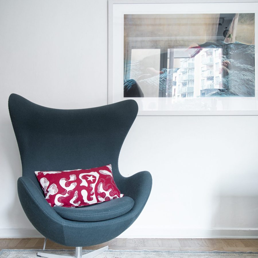 STOCKHOLM, SWEDEN - Feb 10, 2016: Danish designer Arne Jacobsen EGG Easy Chair on a rug with picture hanging on wall
