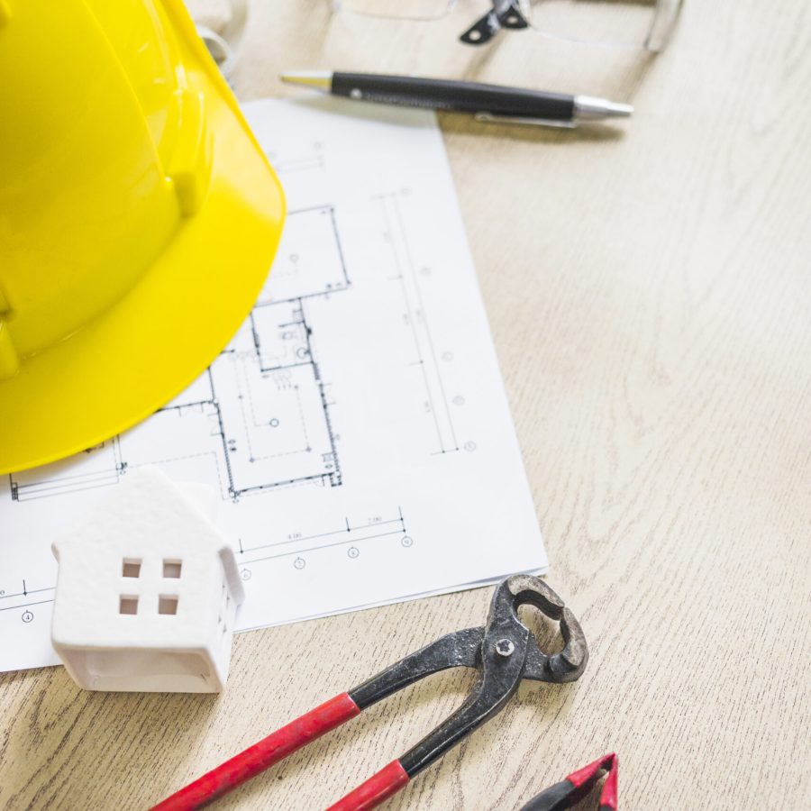 toy-house-near-safety-construction-gear